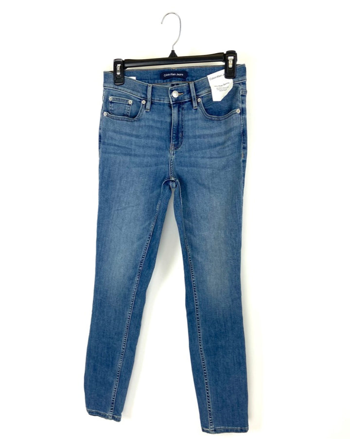 Medium Wash Mid Rise Skinny Jean - Size 25, 26, 27