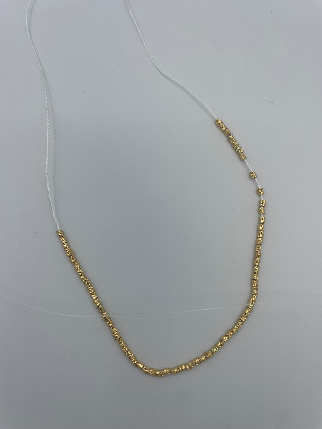 White String Necklace With Gold Beads