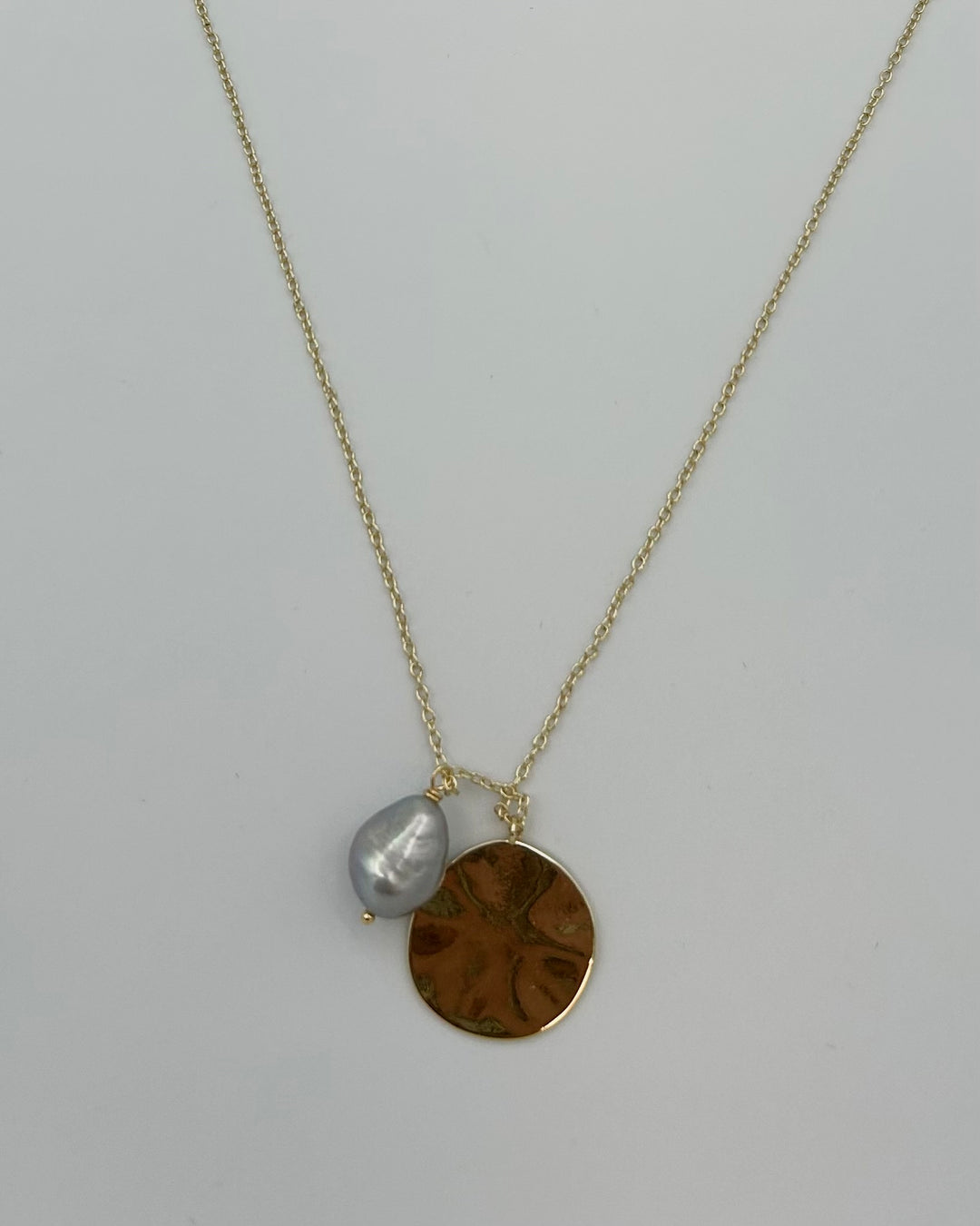 Gold Necklace with Circular and Pearl-Like Charm